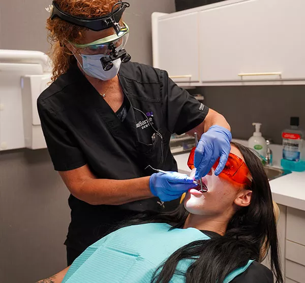 Performing dental exam on patient